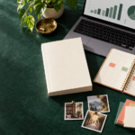 Book marketing strategies planning workspace with a book, calendar, laptop analytics, and social content ideas.